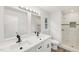 Modern bathroom with double sinks, a tiled walk-in shower, and stylish fixtures at 2606 Newquay St, Durham, NC 27705