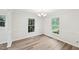 Bright dining area with hardwood floors, windows and elegant chandelier at 2606 Newquay St, Durham, NC 27705