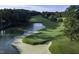 Aerial view of a lush golf course with a pristine pond and manicured greens at 27425 Walker, Chapel Hill, NC 27517