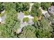 Overhead view of a home with mature trees, lush landscaping, and an expansive driveway at 27425 Walker, Chapel Hill, NC 27517