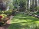 Well maintained backyard featuring a manicured lawn and mature landscaping at 27425 Walker, Chapel Hill, NC 27517