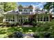 Well-manicured backyard featuring a stone patio and lush greenery at 27425 Walker, Chapel Hill, NC 27517