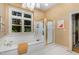 Bright bathroom with a soaking tub, a separate shower, a window with natural light, and a chandelier at 27425 Walker, Chapel Hill, NC 27517