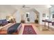 Spacious bedroom featuring a ceiling fan, large window, and doorway to bathroom at 27425 Walker, Chapel Hill, NC 27517