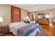 Relaxing bedroom features soft lighting, king bed, decorative accents, and an attached bathroom at 27425 Walker, Chapel Hill, NC 27517
