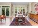 Elegant dining room bathed in light, featuring a large window and classic furnishings at 27425 Walker, Chapel Hill, NC 27517
