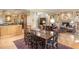 Open concept dining room with wooden table and seating, adjacent to the kitchen and living areas at 27425 Walker, Chapel Hill, NC 27517