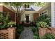 Inviting entrance with brick walkway, potted plants, and a wooden front door at 27425 Walker, Chapel Hill, NC 27517