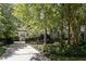 Charming home with a long driveway framed by mature trees and landscaped garden at 27425 Walker, Chapel Hill, NC 27517