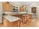 Well-equipped kitchen features wooden cabinetry, granite countertops, and a kitchen island at 27425 Walker, Chapel Hill, NC 27517