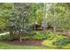 Manicured landscaping featuring mature trees, ferns, and colorful ground cover at 27425 Walker, Chapel Hill, NC 27517