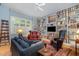 Comfortable living room features custom built-in bookshelves, comfortable seating, and lots of natural light at 27425 Walker, Chapel Hill, NC 27517