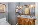 Chic powder room with a wood vanity, marble countertop, and stylish fixtures at 27425 Walker, Chapel Hill, NC 27517