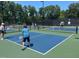 People enjoy an active game of pickleball on well-maintained community courts at 27425 Walker, Chapel Hill, NC 27517