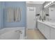 Light and airy bathroom showcasing a tub, long vanity, and neutral color scheme at 31 Bucking Saddle Way, Willow Springs, NC 27592