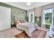 Stylish bedroom featuring two-toned walls, two windows, and a comfortable bed adorned with decorative pillows at 31 Bucking Saddle Way, Willow Springs, NC 27592