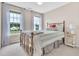 Charming bedroom with natural light streaming through two windows and a comfortable iron bed at 31 Bucking Saddle Way, Willow Springs, NC 27592