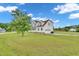 Charming two-story white home with a well-maintained lawn, attached garage, and inviting curb appeal at 31 Bucking Saddle Way, Willow Springs, NC 27592