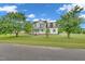 Inviting two-story home featuring a classic porch, well-manicured lawn, and mature shade trees at 31 Bucking Saddle Way, Willow Springs, NC 27592