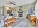 Cozy living room with a fireplace, decorative ceiling fan, and comfortable furnishings at 31 Bucking Saddle Way, Willow Springs, NC 27592
