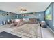 Spacious living room with a large sectional sofa, decorative shelves, and a cozy, inviting atmosphere at 31 Bucking Saddle Way, Willow Springs, NC 27592
