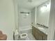 Bright bathroom features modern fixtures, a granite vanity, and a bathtub-shower combo with tiled walls at 310 E Woodall St, Smithfield, NC 27577