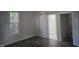 Bright bedroom with wood-look flooring and a barn door to the bathroom at 310 E Woodall St, Smithfield, NC 27577