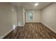 Spacious bedroom with a window, white trim, and vinyl plank flooring at 310 E Woodall St, Smithfield, NC 27577