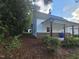 Charming home exterior with side yard, a covered porch, and mature landscaping at 310 E Woodall St, Smithfield, NC 27577