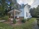 Charming home featuring a covered porch with wooden posts and a brick foundation at 310 E Woodall St, Smithfield, NC 27577