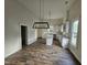 An open kitchen with white cabinetry, stainless appliances, and an island at 310 E Woodall St, Smithfield, NC 27577