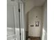 Unfinished laundry room featuring a washer hookup, wood floors, and an adjacent storage area at 310 E Woodall St, Smithfield, NC 27577