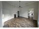 Cozy living room with wood-look floors, brick fireplace, and views into other living spaces at 310 E Woodall St, Smithfield, NC 27577
