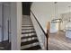 View of stairs, open floor plan, dining room, and luxury vinyl plank flooring at 310 E Woodall St, Smithfield, NC 27577