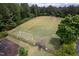 Aerial view of a gated fenced in soccer field in a wooded community at 312 Bridgegate Dr, Cary, NC 27519