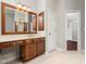 Bathroom vanity features a large mirror, storage cabinets and drawers, and tiled floors at 312 Bridgegate Dr, Cary, NC 27519