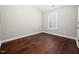 Bedroom with hardwood floors and one window with white shutters at 312 Bridgegate Dr, Cary, NC 27519