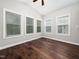 A bedroom featuring dark wood floors, multiple windows and a ceiling fan for comfortable living at 312 Bridgegate Dr, Cary, NC 27519