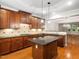 Modern kitchen featuring granite countertops, stainless appliances, and hardwood floors at 312 Bridgegate Dr, Cary, NC 27519