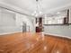 Open-concept living room features hardwood floors, a staircase, and a view into the kitchen at 312 Bridgegate Dr, Cary, NC 27519