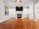 Inviting living room featuring a fireplace, built-in shelves, and hardwood floors at 312 Bridgegate Dr, Cary, NC 27519