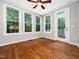 Bright sunroom with hardwood floors, a ceiling fan and multiple windows, offering natural light and views at 312 Bridgegate Dr, Cary, NC 27519