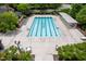 Aerial view of community lap pool with sunbathing area and shaded seating at 312 Bridgegate Dr, Cary, NC 27519