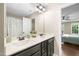 Bathroom featuring double sinks with modern fixtures and a view into the main bedroom at 317 Chamberlain Dr, Clayton, NC 27527