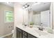 Bathroom with double sink vanity, tile floor, framed mirror and a shower/tub combo at 317 Chamberlain Dr, Clayton, NC 27527