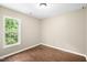 Bedroom with wood floor, a window with backyard views, and light walls at 317 Chamberlain Dr, Clayton, NC 27527