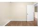 Bedroom featuring wood floors, neutral paint, and a white door at 317 Chamberlain Dr, Clayton, NC 27527