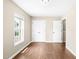 Bedroom with wood floor, double closets, and a bright window overlooking the front yard at 317 Chamberlain Dr, Clayton, NC 27527