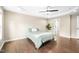 Bedroom with dark floors, neutral walls, a tray ceiling with fan, and adjacent bathroom at 317 Chamberlain Dr, Clayton, NC 27527