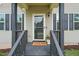 Inviting front porch with a welcoming doormat and stylish accents at 317 Chamberlain Dr, Clayton, NC 27527